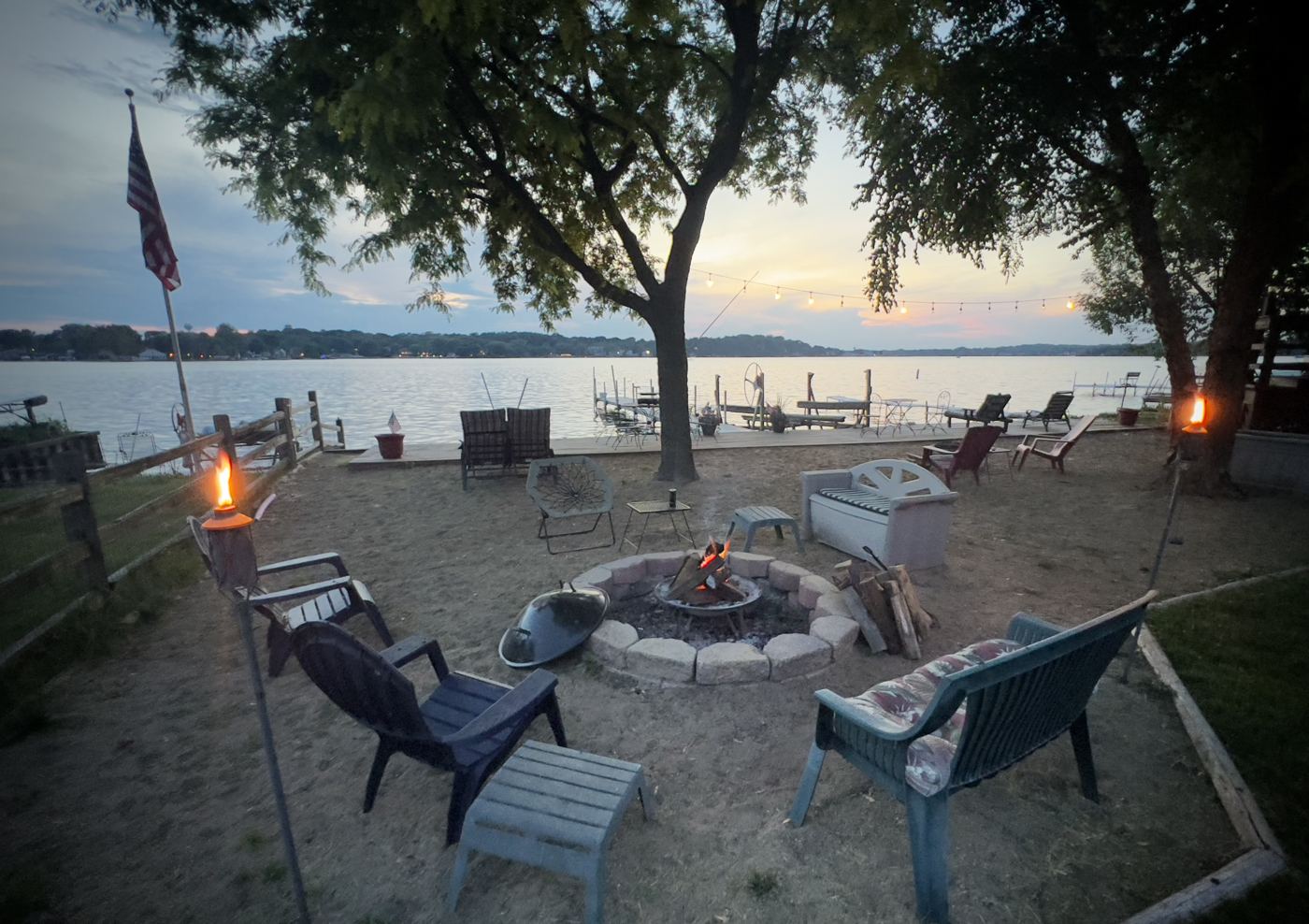 Lakefront fire pit and beach at dusk on Mineola Bay, Chain O'Lakes